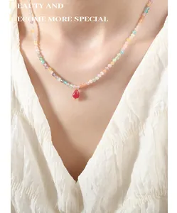 Bohemian colorful crystal stone necklace with a red teardrop pendant on a female model
