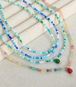 Close-up of bohemian handmade beaded necklaces with faceted crystal stones and colorful beads