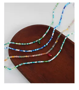 Detail of bohemian handmade beaded necklaces with natural stones and teardrop pendants