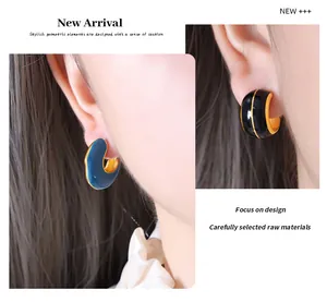 Detail view of vintage geometric C-shaped earrings with colorful enamel and 18K gold plating