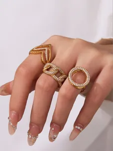 Nahaufnahme vergoldeter Ringe mit Zirkonia auf Händen, inklusive V-Form und Ketten-Stile