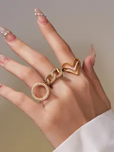 Detail von vergoldeten Ringen im Set mit Zirkonia-Steinen in Herz- und Kettendesigns