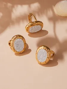 Detailed macro view of 18k gold plated stainless steel clover rings with pavé crystals