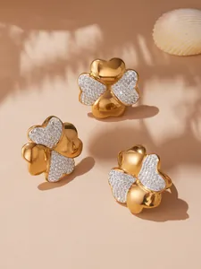 Detailed macro view of 18k gold plated four-leaf flower rings with micro-pave zircons