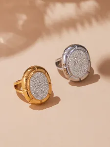 Detail shot of oval encrusted rings in gold and silver finish with crystal pavé stones