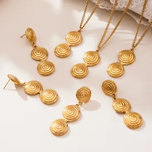 Golden stainless steel jewelry set featuring twisted spiral pendant necklaces and earrings
