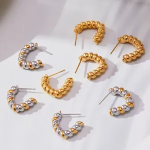 Modern twisted C-shape hoop earrings in gold and silver finish with spiral design