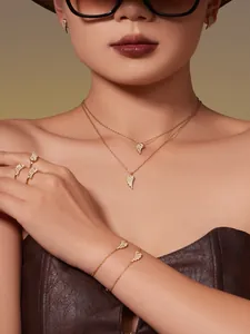 Detailed view of wing-shaped jewelry set with micro-set zircons in 18k gold plating