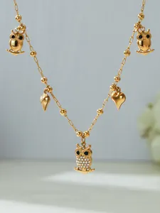 Detailed close-up of 18k gold-plated necklace with 5A zircon owl and heart pendants