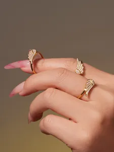 Detailed close-up of 18k gold plated angel wing rings featuring pave-set 5A cubic zirconia