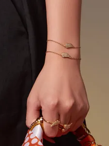 Close-up of gold plated wing jewelry set with sparkling 5A zircon on wrist and fingers