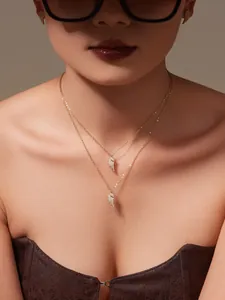 Close-up of 18k gold plated wing necklace and earrings set with shimmering 5A cubic zirconia