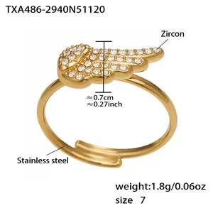 Detailed view of wing-shaped ring in 18k gold-plated steel with zircon and size 7 label