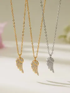 Close-up of sparkling zircon angel wing pendants in gold and silver stainless steel