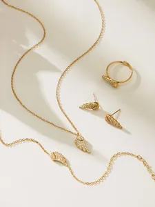 Detail shot of gold-plated angel wing jewelry set with sparkling pavé zircon stones