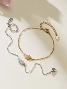 Detailed view of 18k gold and silver plated angel wing bracelets with cubic zirconia stones
