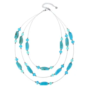 Detailed view of bohemian three-layer necklace with turquoise stones and blue crystal beads