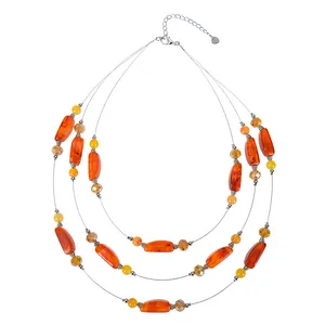 Three-layer bohemian necklace featuring orange resin beads and faceted crystal spacers