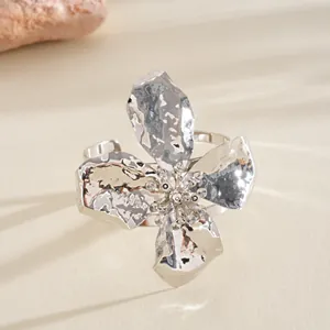 Close-up of silver crinkled metal flower cuff bracelet with hammered texture
