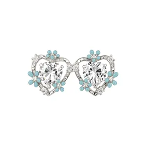 Elegant heart stud earrings featuring blue enamel flowers and clear sparkling crystals