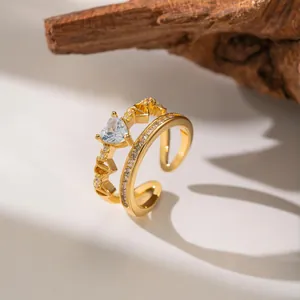Detail view of a gold-plated open ring featuring a sparkling heart-shaped zircon stone