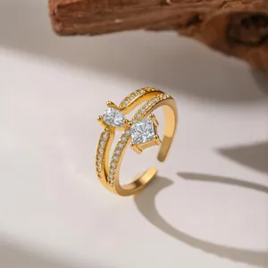 Detailed close-up of a gold-plated adjustable open ring with pear and square cut zircons