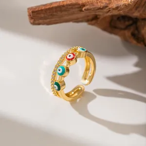 Detail shot of an adjustable gold ring with micro-pave zircons and colorful evil eyes.
