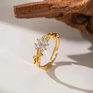 Detailed view of a gold adjustable flower ring with sparkling clear zircon crystals.