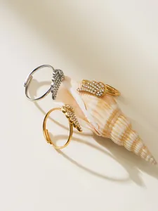 Detailed view of angel wing rings with sparkling zircons on natural seashells