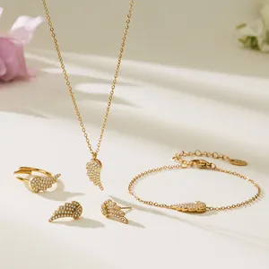 Sparkling angel wing jewelry set in gold finish including necklace, bracelet, and ring