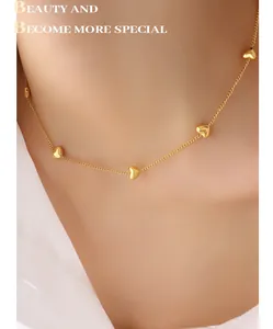 Close-up of gold heart charm necklace worn on collarbone for a sweet minimalist look
