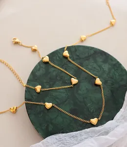 Detail of gold heart pendant necklace on elegant marble display with lobster clasp