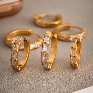 Gold plated stainless steel huggie earrings with channel set rectangular zirconias