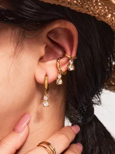 Close-up of gold 18k plated cat earrings featuring sparkling cubic zirconia on ears
