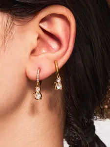 Detail of 18k gold plated cat earrings featuring clear zircon stones and crystal accents