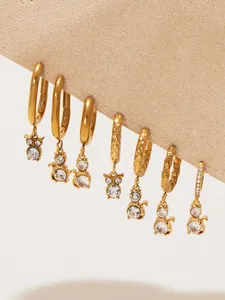 Detailed macro view of 18k gold-plated cat and owl hoop earrings with white zircons