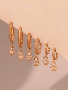 Detailed view of three pairs of 18k gold plated astronaut earrings with 5A cubic zirconia