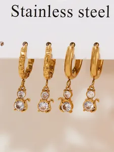 Close-up of set of two 18k gold plated stainless steel cat earrings with cubic zirconia