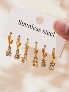 Detailed close-up of 18k gold-plated stainless steel cat and elephant earrings set