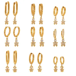 Set of 9 pairs gold plated hoop earrings with sparkling zircon astronaut pendants