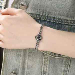 Detailed close-up of a stainless steel beaded bracelet with a knight helmet charm.