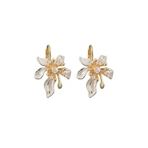 Elegant French style camellia flower earrings with micro-set zircons and gold accents.