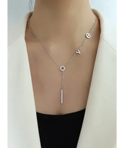 Detail of silver Y-shaped necklace with LOVE letter charms worn on a model