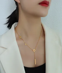 Detail of 18k gold plated titanium steel necklace with LOVE letters and bar pendant