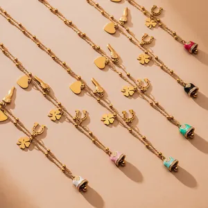 Golden multi-charm necklace with colorful enamel bells and lucky clover pendants