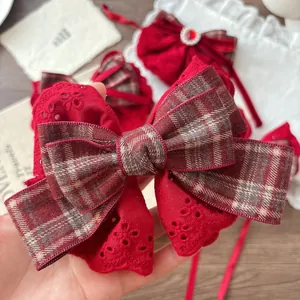 Large festive red lace bow hair clip for girls featuring vintage plaid ribbon detailing
