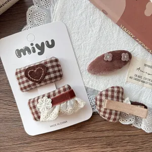 Brown plaid and heart embroidery fabric hair bow clips set for girls on wooden desk