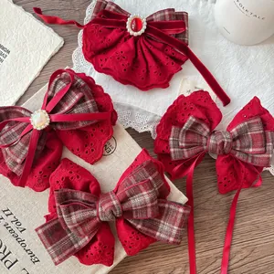 Detail of red lace and velvet bow hair clips with pearls on a vintage background