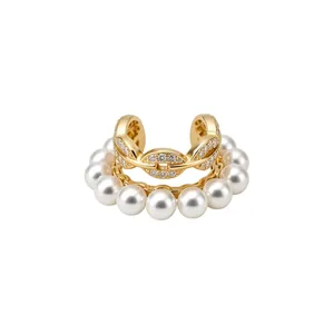 Elegant gold-tone double-layered ear cuff with white pearls and pavé zirconia stones.