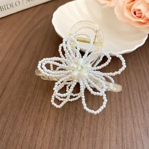 Close-up of pearl flower and bow hair claw clip with sweet fairy style design